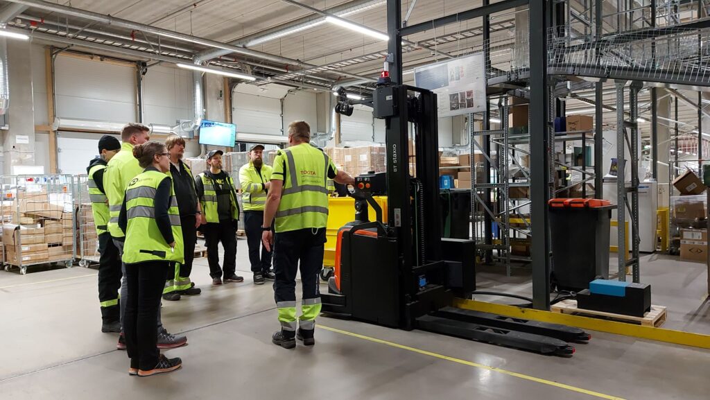 logistics workers familiarize themselves with forklift automation